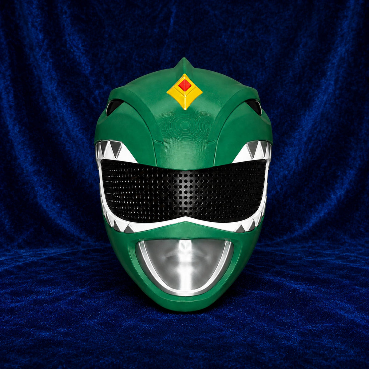 Fully assembled Green Ranger 3D printed helmet on blue velvet