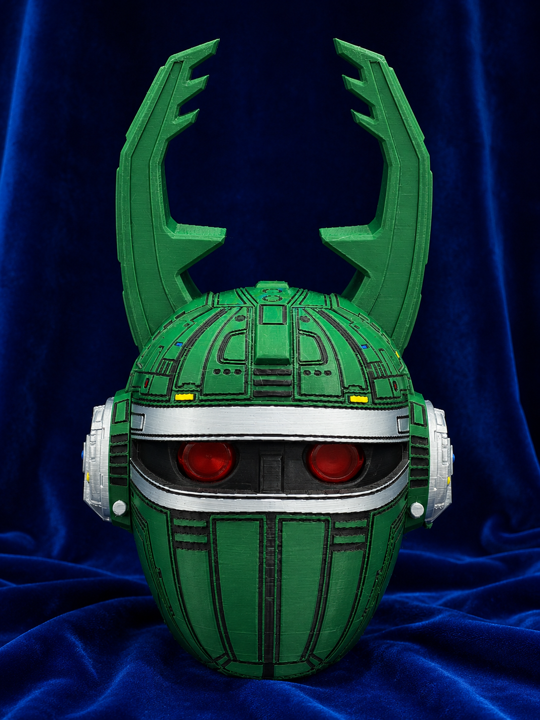Big Bad Beetleborgs Green Beetleborg finished cosplay helmet, front view on blue velvet