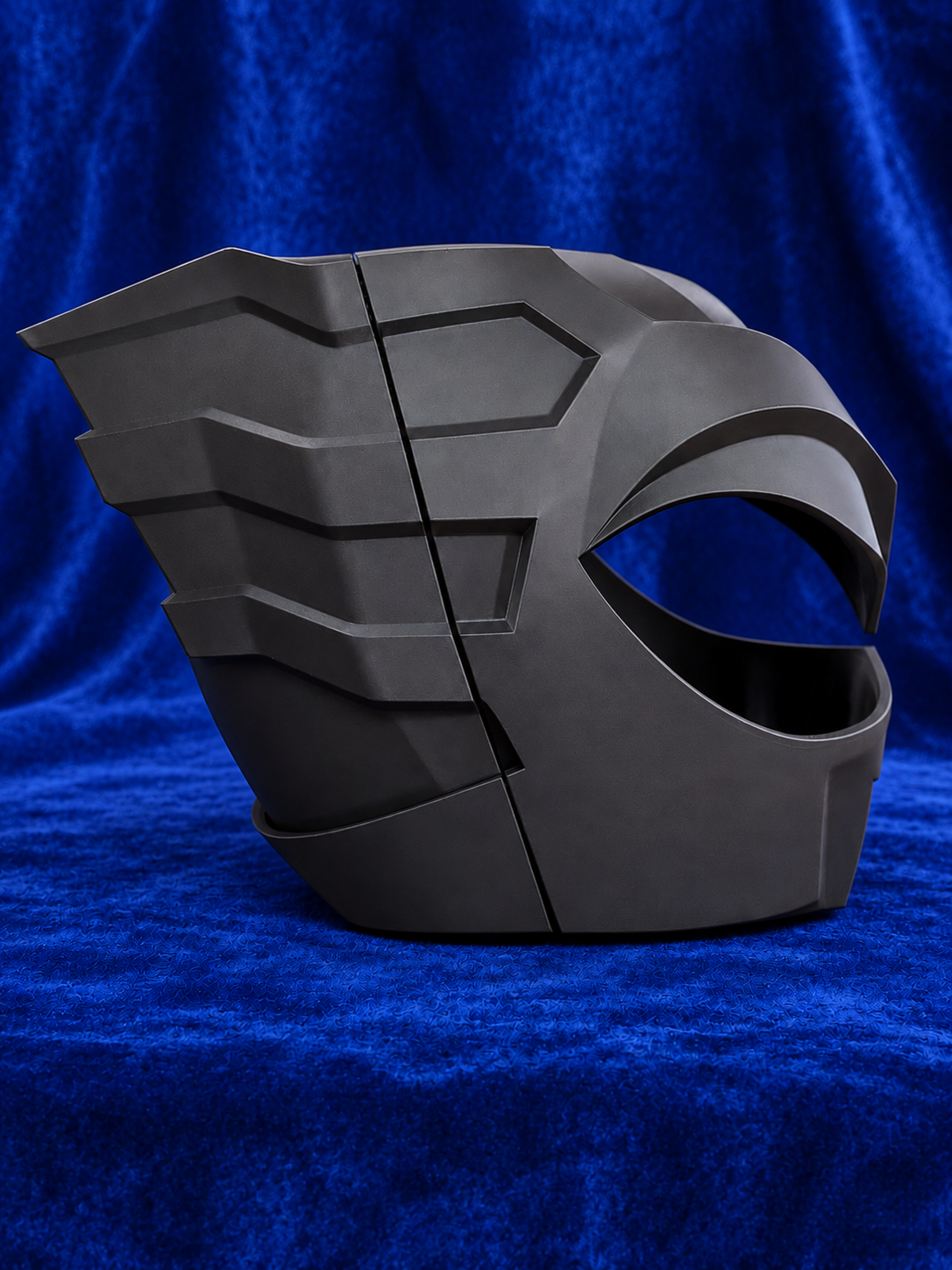 Psycho Ranger raw black PLA helmet kit on blue velvet, side profile